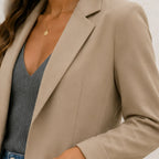 Close-up of women's khaki lapel slim blazer fabric and tailoring