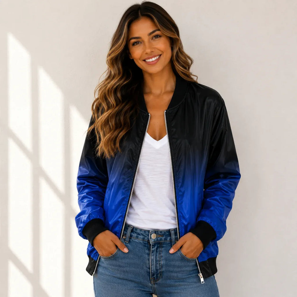 Woman wearing a blue and black bomber jacket with a white tank top and jeans