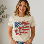 Smiling woman wearing Women's Floral American Flag Graphic Tee in cream with patriotic red, white and blue floral design.