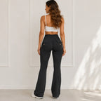 Back view of women's high-waisted flared yoga pants with cargo-style pockets