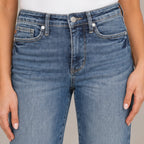 Close-up of women's Judy Blue tummy control straight jeans in medium wash denim featuring the waistband, button closure, belt loops, and premium denim texture.