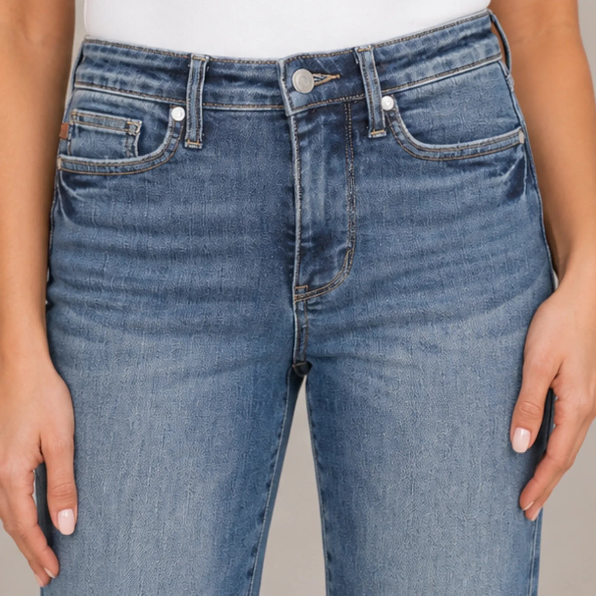 Close-up of women's Judy Blue tummy control straight jeans in medium wash denim featuring the waistband, button closure, belt loops, and premium denim texture.