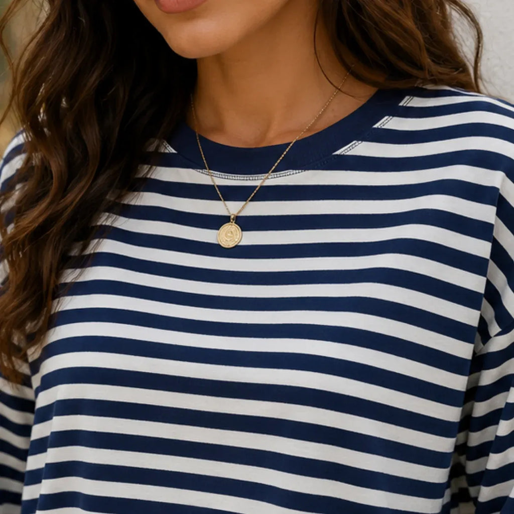 Close-up of women's navy striped long-sleeve crew neck top showing stripe pattern and neckline