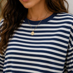 Close-up of women's navy striped long-sleeve crew neck top showing stripe pattern and neckline