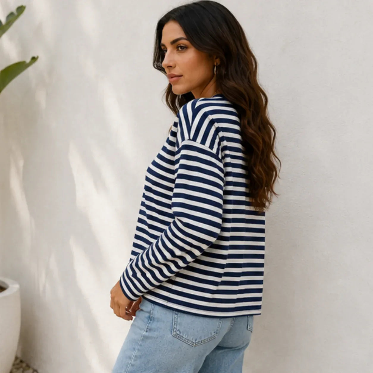 Women's navy striped loose-fit long-sleeve crew neck top side view