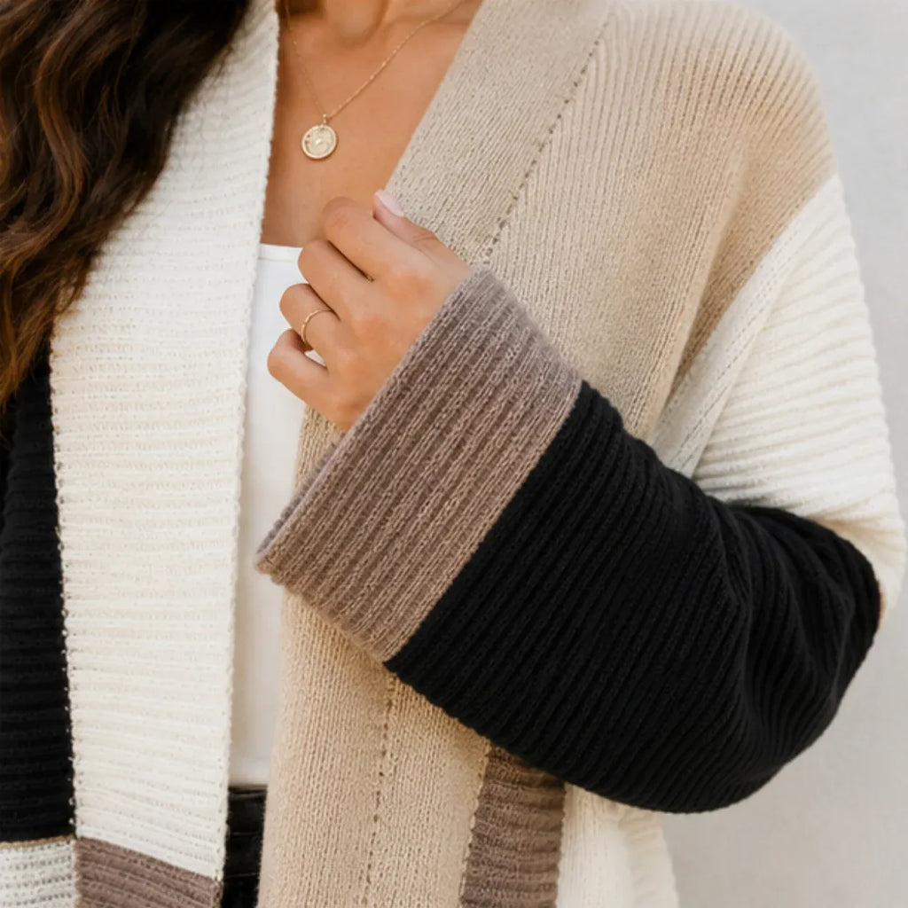 Close-up of women's oversized color block cardigan showing ribbed knit texture and contrasting sleeves