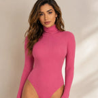 Women's pink ribbed turtleneck bodysuit front view with long sleeves and soft stretch fabric.