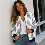 Woman wearing a white bomber jacket with black feather print and jeans
