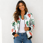 Woman wearing a white tropical floral bomber jacket with a white tank top and jeans