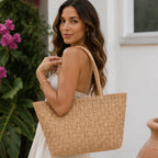 Side view of a woman carrying a woven straw tote bag with double handles and a spacious design.