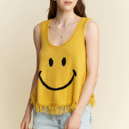 Lifestyle view of the yellow smiley tank styled with denim shorts for summer.