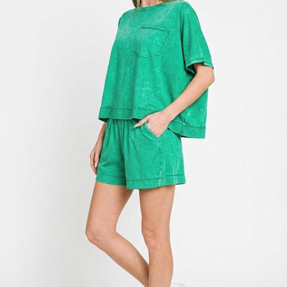 Woman wearing a green outfit with a plain background