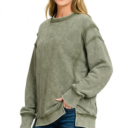 Lifestyle image of the distressed exposed-seam sweatshirt in Dark Olive.